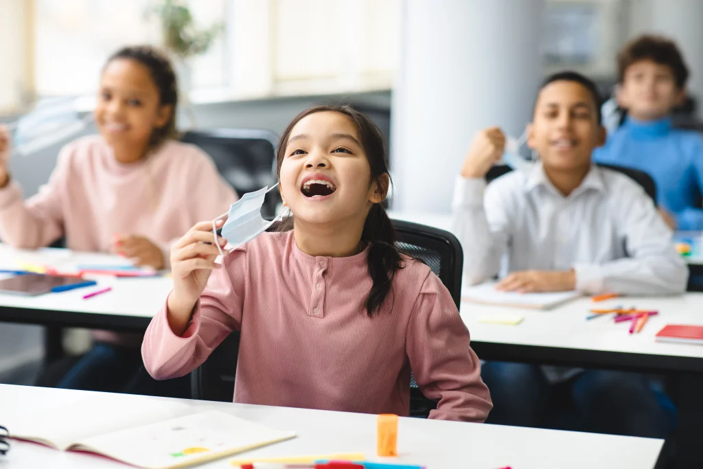 smiling-pupils-taking-off-disposable-medical-face-2023-11-27-05-25-16-utc